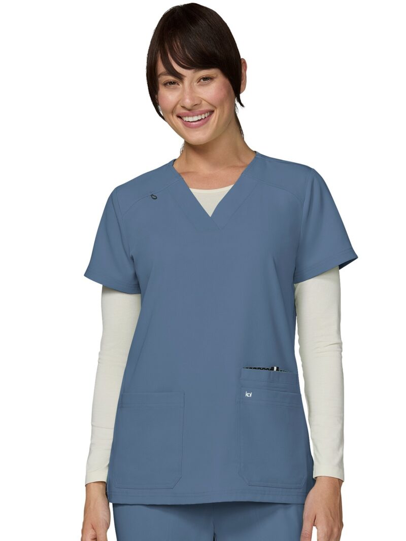 A best-selling ladies koi scrub top with v-neck and front loading pockets