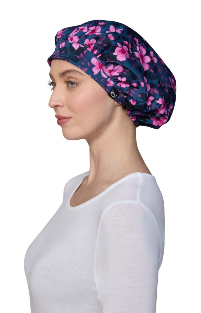 Colorful flowers and blooms print koi shower scrub cap designed for afros and fuller/longer hairstyles, equipped with ear-saving buttons for face masks.